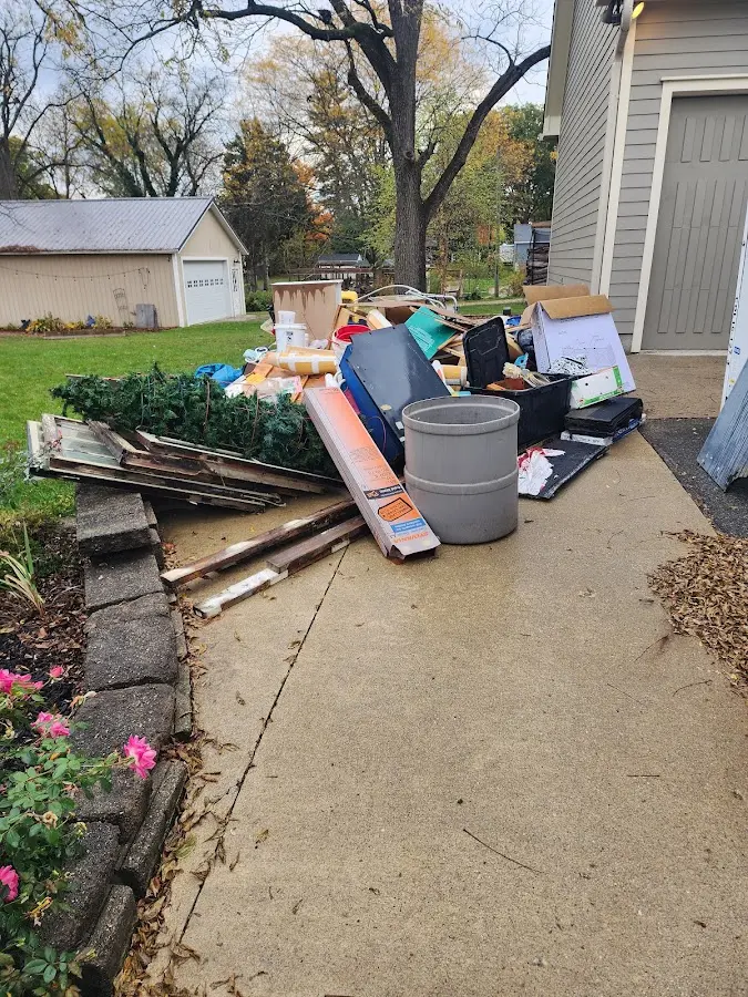 Dumpster being loaded with debris for Roofing Dumpster Rental in Durham